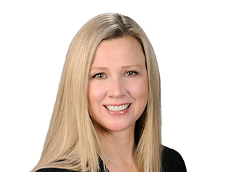 Professional headshot of a blonde woman smiling