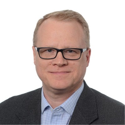 Portrait of a man with glasses, speaker at a conference.